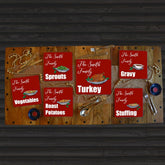 a set of personalised Christmas placemats in red on a dining table.